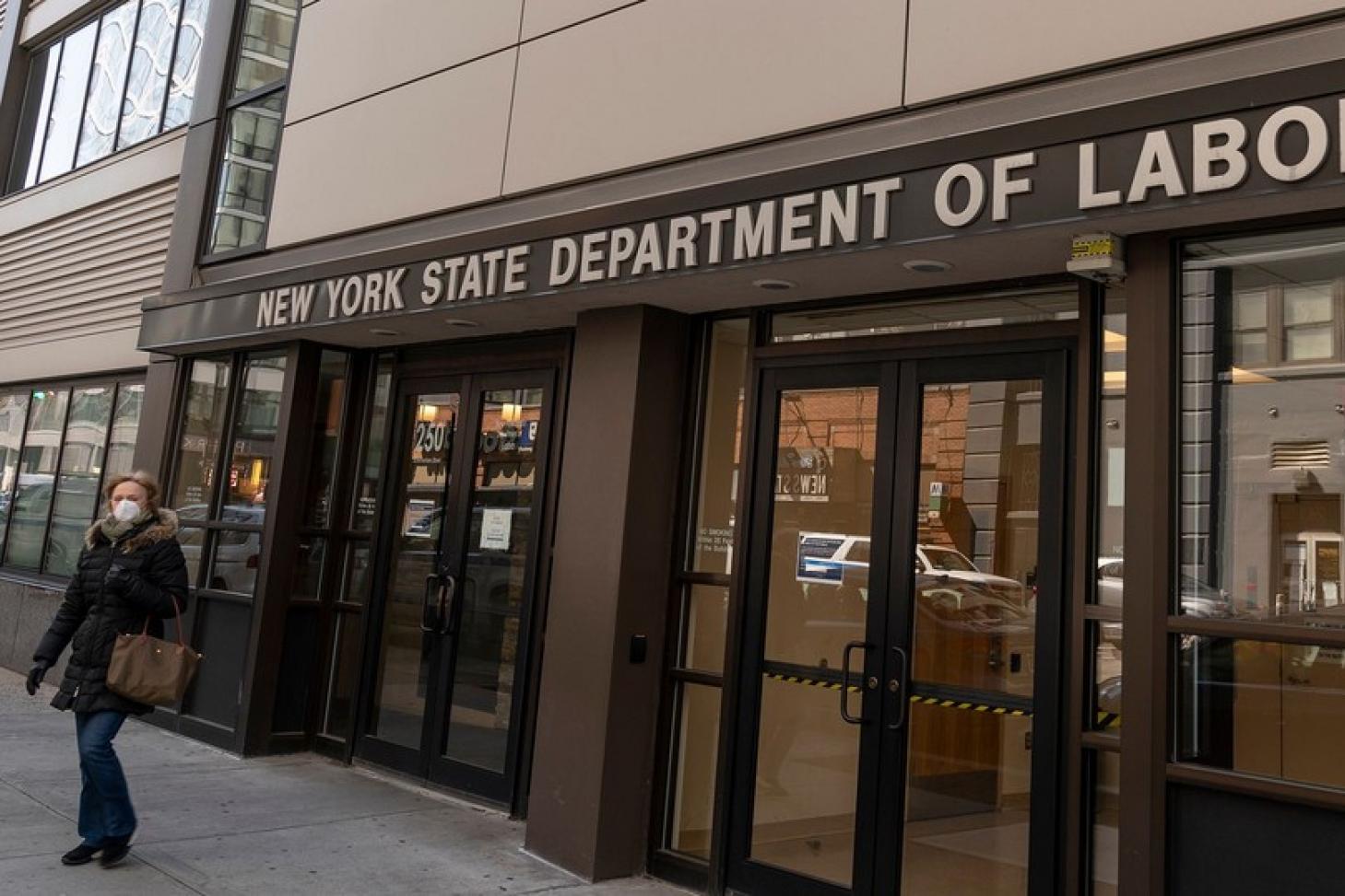 A masked pedestrian outside the New York State Department of Labor